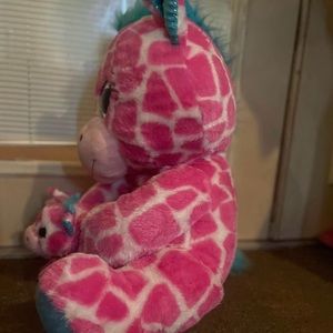 Big pink & white giraffe with baby